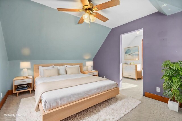 carpeted bedroom with ceiling fan and lofted ceiling