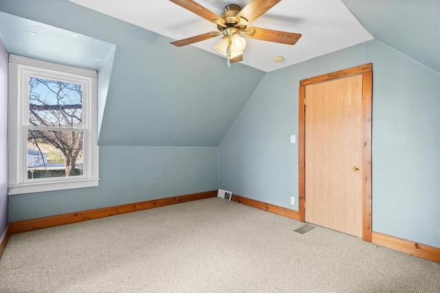 additional living space with ceiling fan, carpet floors, and vaulted ceiling