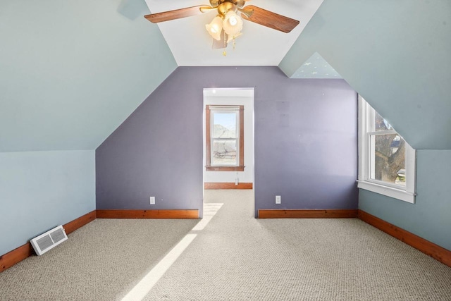 bonus room featuring ceiling fan, light colored carpet, and lofted ceiling