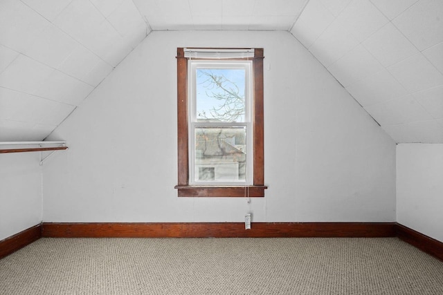 bonus room with carpet and vaulted ceiling