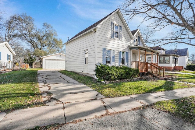 view of front of home featuring a porch, an outbuilding, a front yard, and a garage