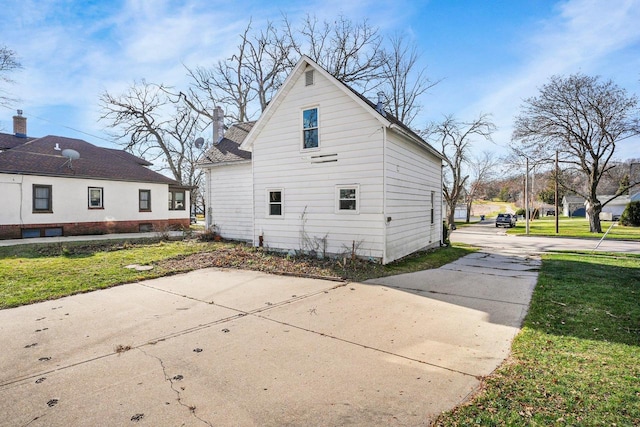 back of property featuring a lawn