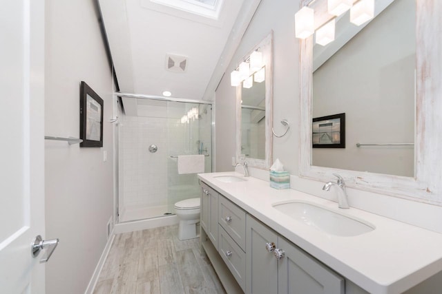 bathroom with hardwood / wood-style floors, vanity, toilet, and a shower with shower door