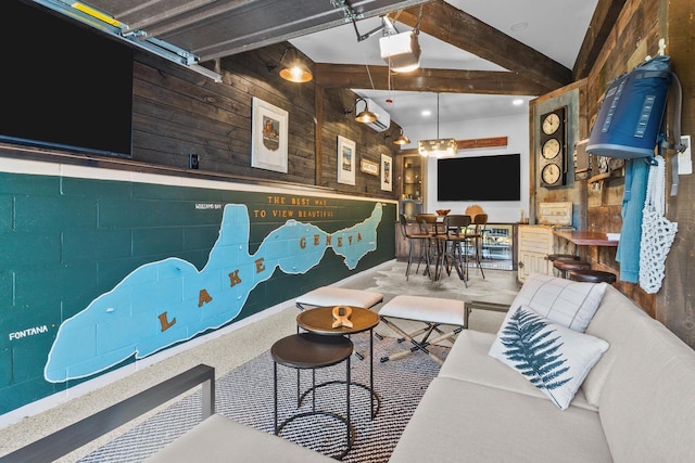 living room with vaulted ceiling with beams and wood walls