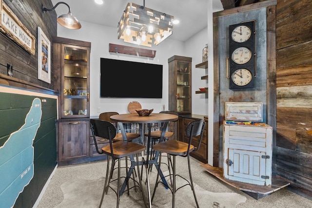 dining space with wood walls