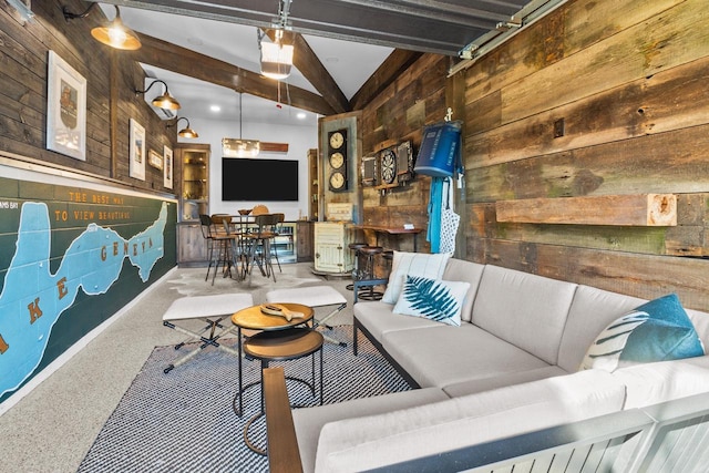 living room with lofted ceiling with beams and wooden walls