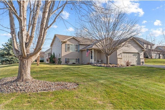 view of front of property with a garage and a front lawn