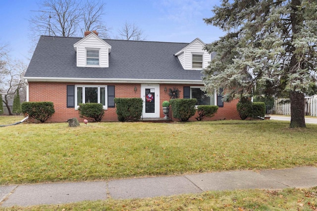 new england style home featuring a front lawn