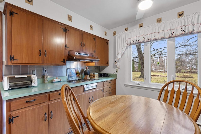 kitchen featuring ceiling fan, backsplash, and stainless steel gas cooktop