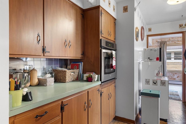 kitchen featuring tasteful backsplash and oven