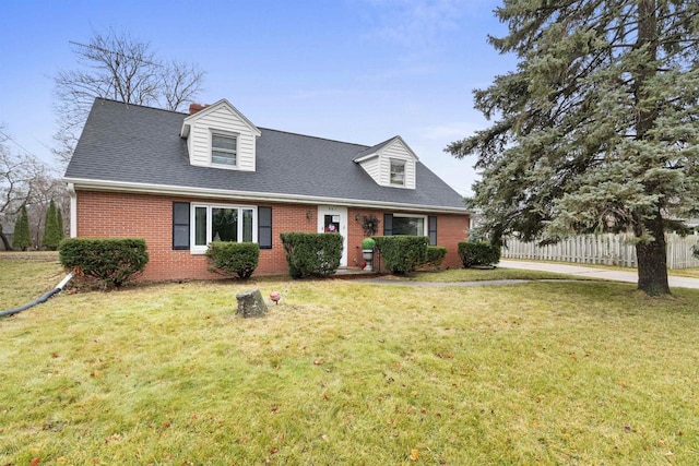 cape cod home with a front lawn