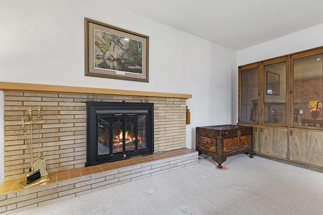 living room featuring carpet flooring and a brick fireplace