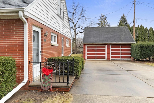 view of side of home with a garage and an outbuilding