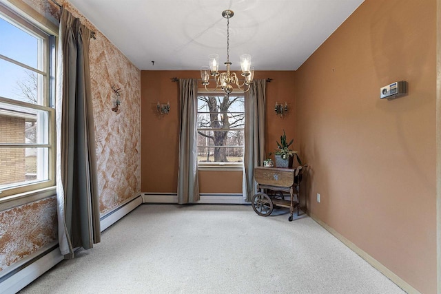 interior space featuring carpet flooring, an inviting chandelier, and a healthy amount of sunlight