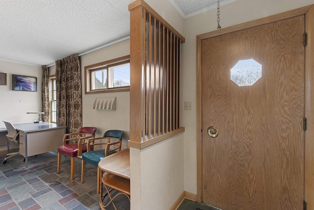 foyer entrance featuring a textured ceiling