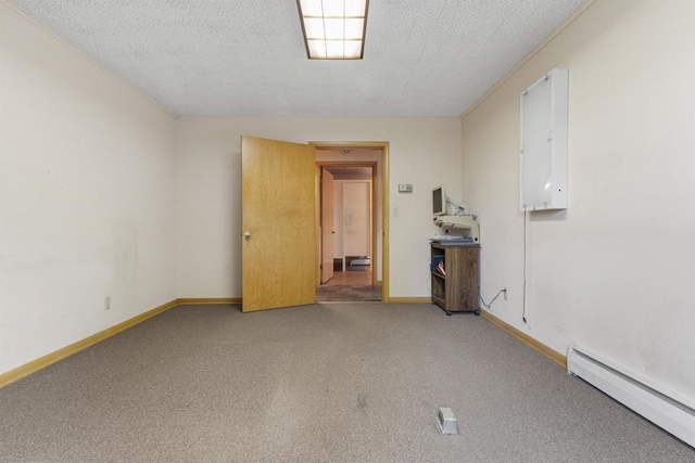 carpeted empty room featuring a textured ceiling and a baseboard heating unit