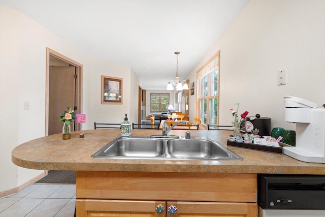 kitchen with hanging light fixtures, sink, a notable chandelier, light tile patterned flooring, and dishwashing machine