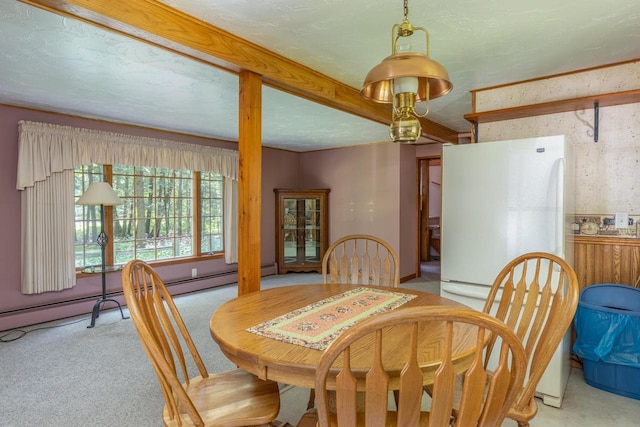 carpeted dining area featuring a textured ceiling