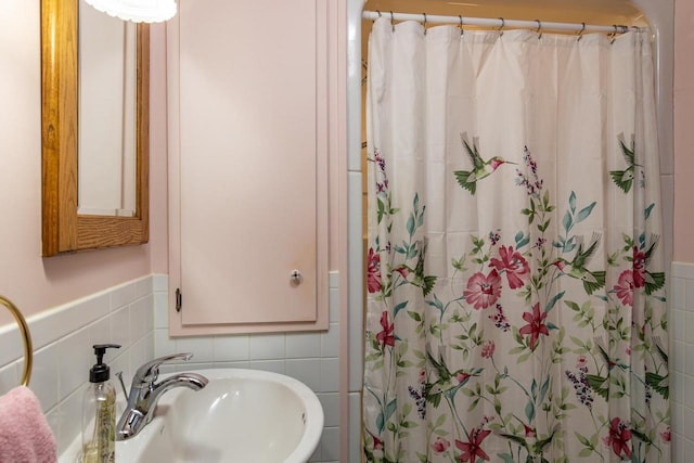 bathroom featuring sink, tile walls, and walk in shower