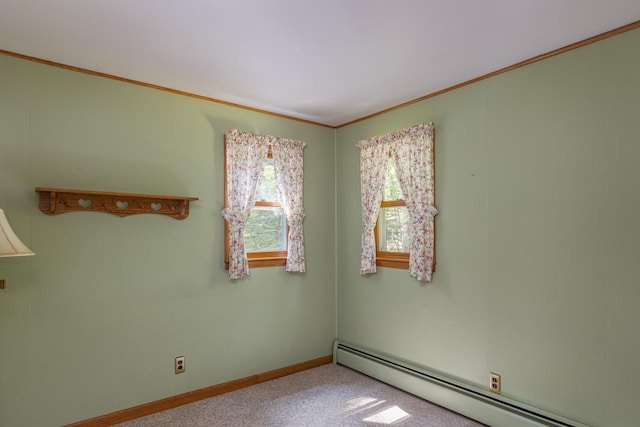 carpeted spare room with ornamental molding and a baseboard radiator