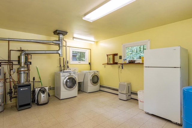 laundry area with washing machine and dryer, gas water heater, and a baseboard heating unit