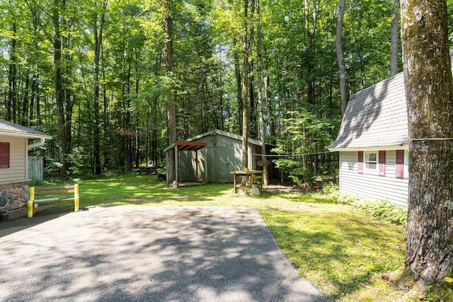 view of yard with a shed and a patio