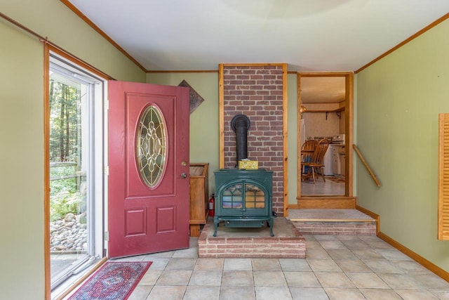 entryway featuring a wood stove, crown molding, and light tile patterned flooring