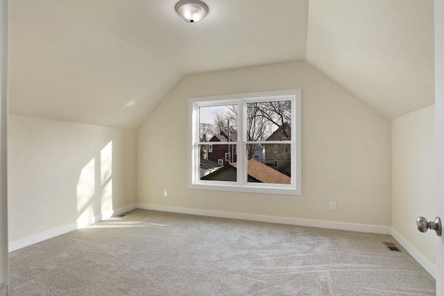 bonus room featuring light carpet and lofted ceiling