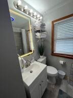 bathroom featuring vanity and toilet