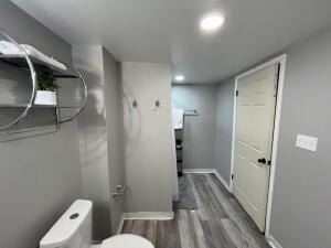 bathroom featuring hardwood / wood-style floors and toilet