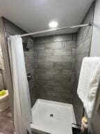 bathroom with toilet and walk in shower