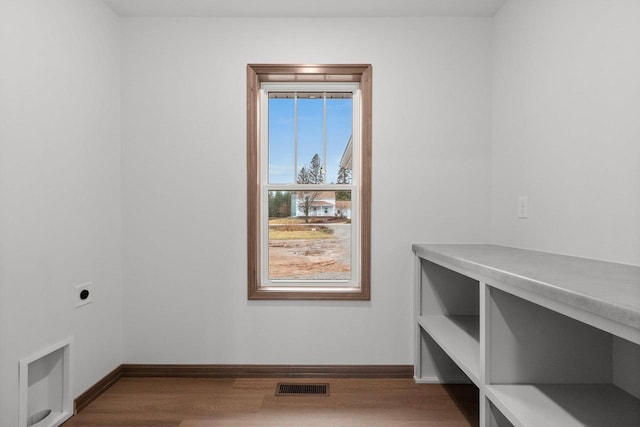 interior space featuring hardwood / wood-style flooring and electric dryer hookup