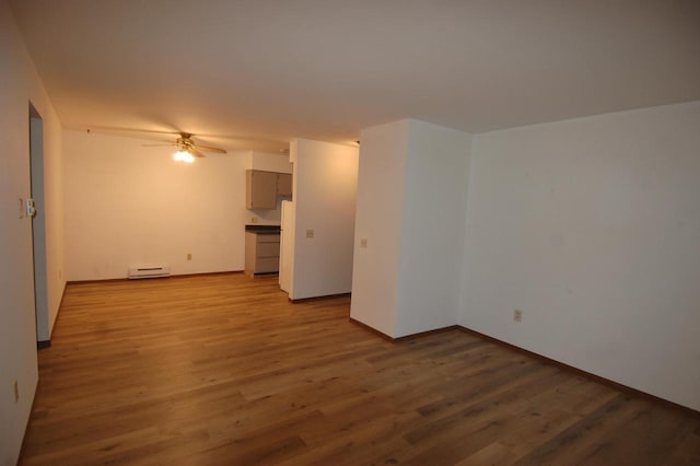 spare room featuring light hardwood / wood-style floors, ceiling fan, and a baseboard heating unit