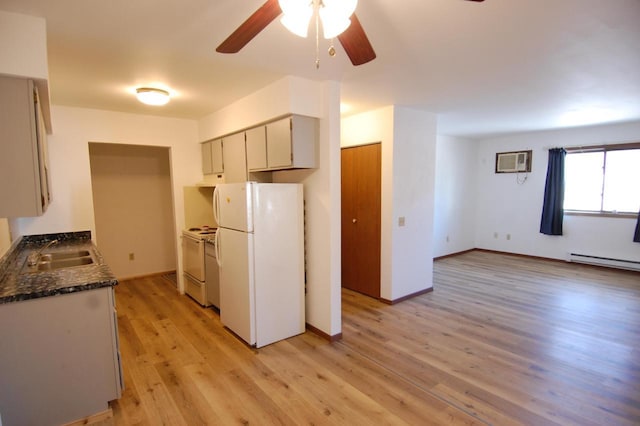 kitchen featuring white appliances, an AC wall unit, light hardwood / wood-style flooring, ceiling fan, and sink