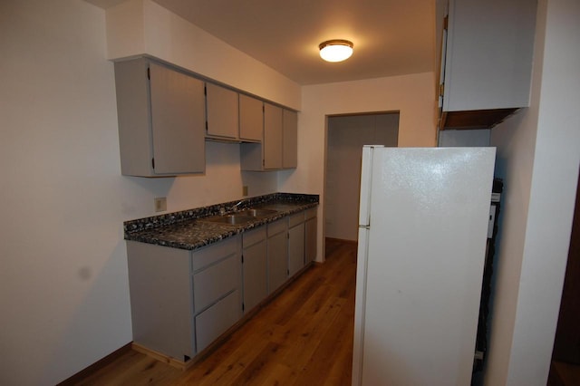 kitchen featuring sink, white fridge, gray cabinetry, and dark hardwood / wood-style floors