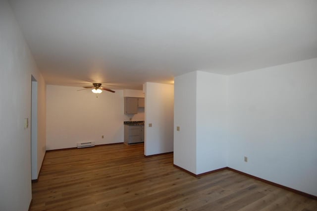 unfurnished living room featuring ceiling fan, dark wood-type flooring, and a baseboard radiator