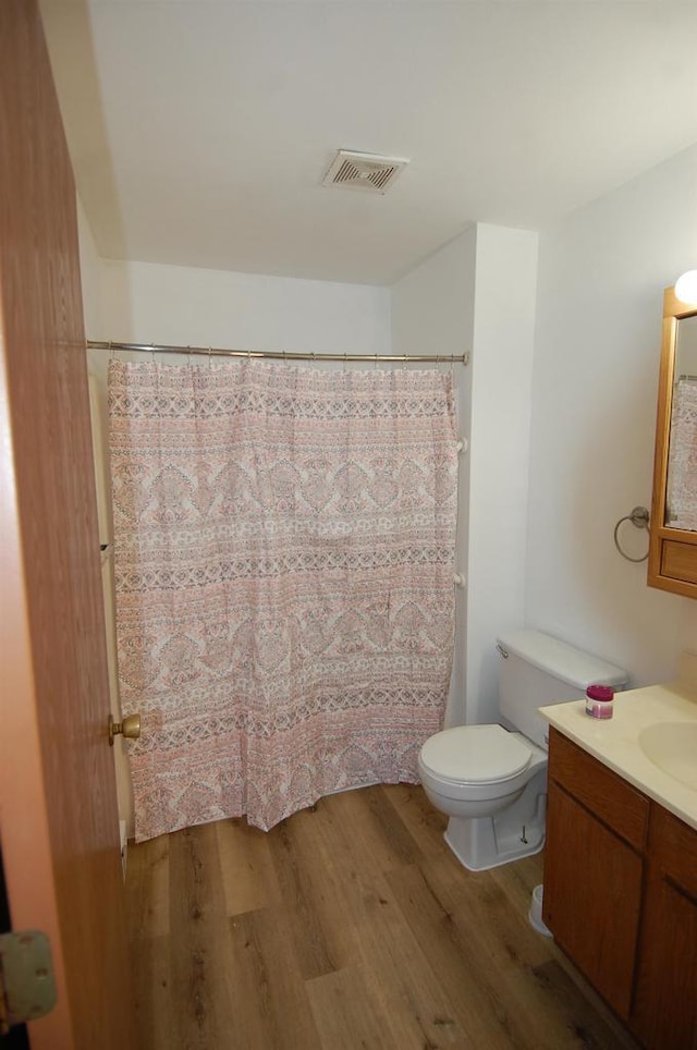 bathroom featuring hardwood / wood-style floors, vanity, and toilet