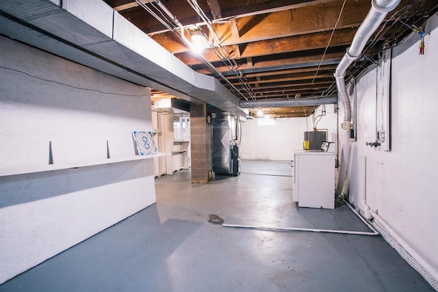 basement featuring washer / dryer and heating unit