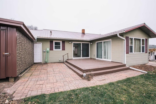 back of house featuring a patio and a deck