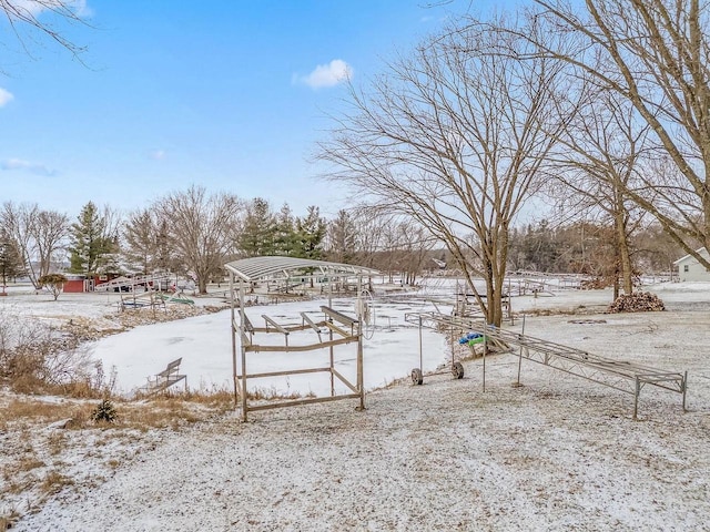 snowy yard featuring a rural view