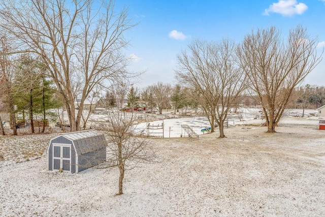 snowy yard featuring an outbuilding