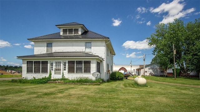 rear view of house with a lawn