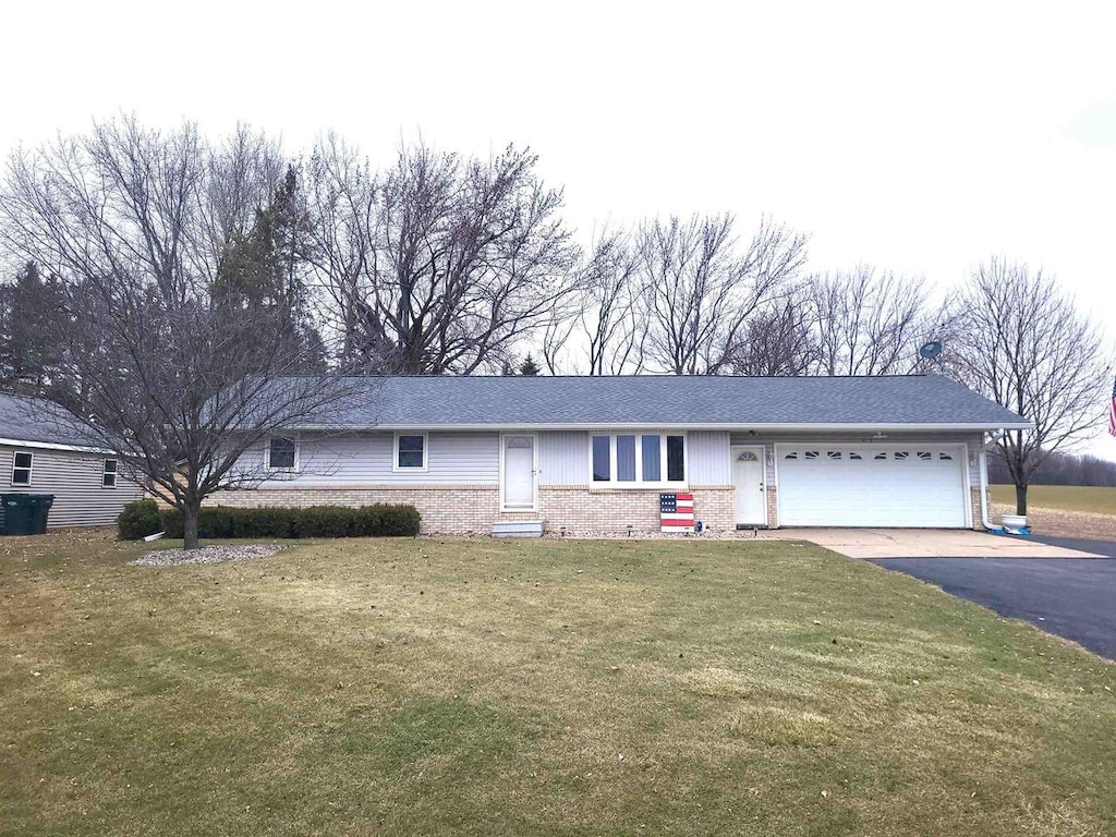 ranch-style house with a front yard and a garage