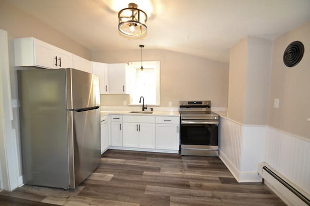 kitchen with dark wood-type flooring, hanging light fixtures, sink, baseboard heating, and appliances with stainless steel finishes