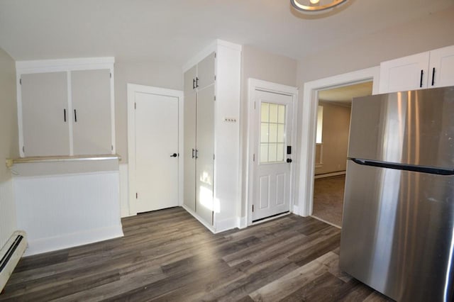 kitchen with baseboard heating, stainless steel fridge, dark hardwood / wood-style flooring, and white cabinets