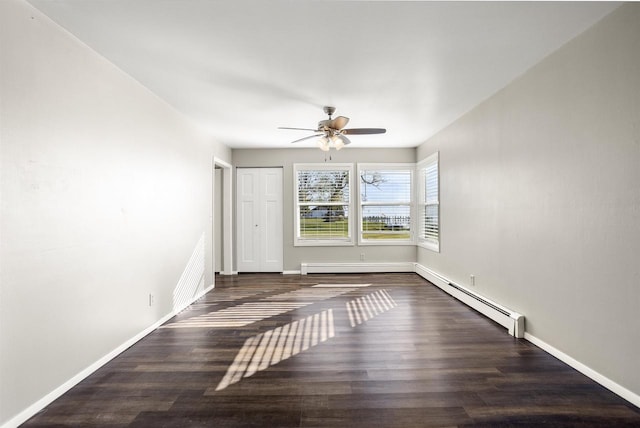 1001 Bay Shore Dr, Oshkosh, WI 54901 - spare room with ceiling fan, dark hardwood / wood-style flooring, and baseboard heating