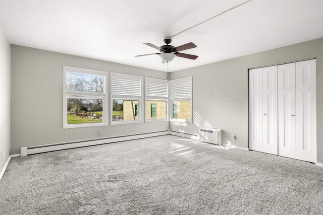 1001 Bay Shore Dr, Oshkosh, WI 54901 - unfurnished bedroom featuring carpet, a wall mounted air conditioner, baseboard heating, ceiling fan, and a closet