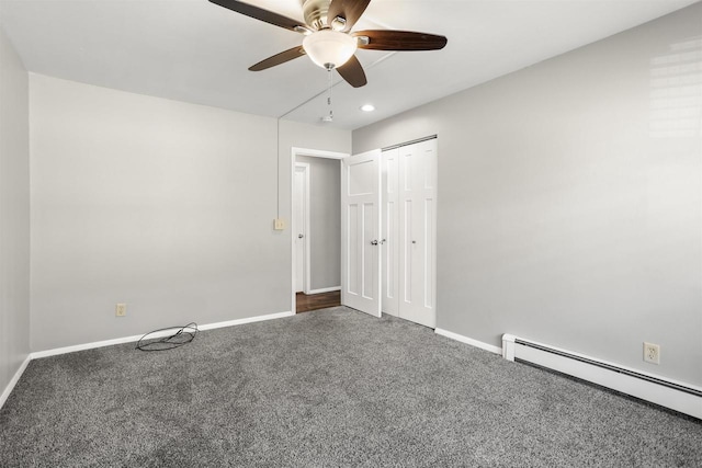 1001 Bay Shore Dr, Oshkosh, WI 54901 - unfurnished bedroom featuring carpet floors, a closet, baseboard heating, and ceiling fan