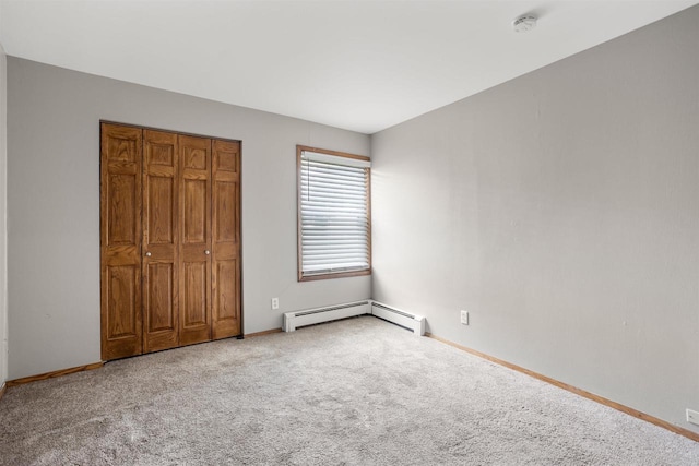 1001 Bay Shore Dr, Oshkosh, WI 54901 - unfurnished bedroom featuring carpet flooring, a closet, and a baseboard radiator