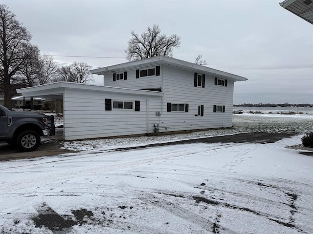 1001 Bay Shore Dr, Oshkosh, WI 54901 - snow covered property with a carport